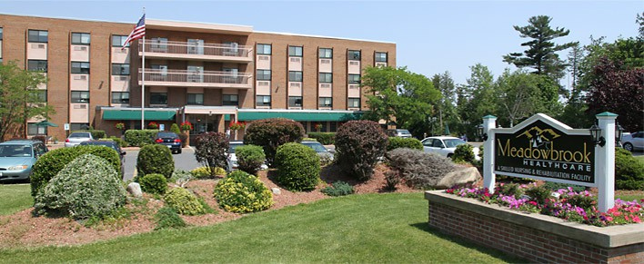 Meadowbrook Healthcare's main entrance and lawn on a sunny day